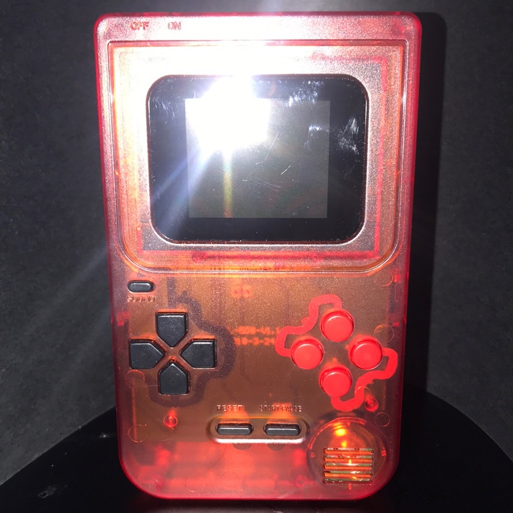 Red and Black Handheld Console with LCD Display and D-pad